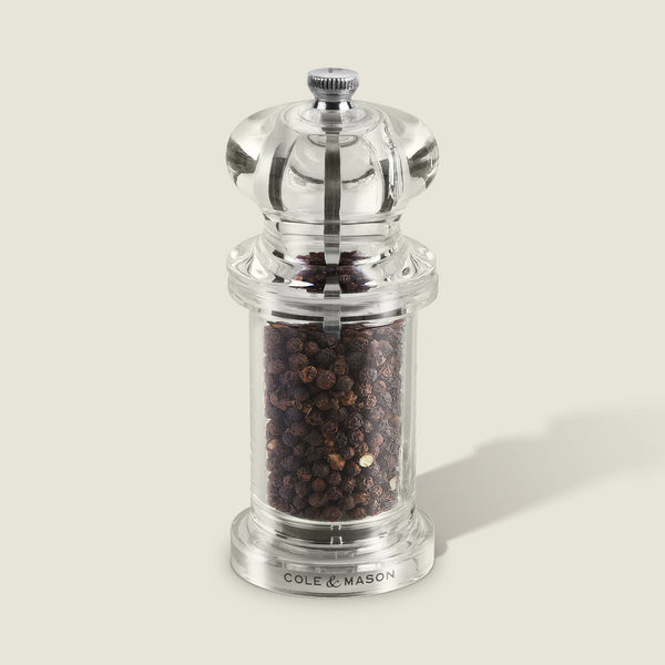 #pepper
A clear acrylic 505 Pepper Mill by Cole & Mason, featuring adjustable settings, whole black peppercorns, a silver top knob, and Cole & Mason label at the base—ideal for Salt & Pepper Mills collections, photographed on a light gray background.