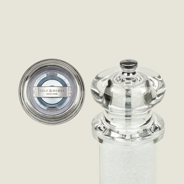 #salt&pepperset
A clear acrylic Cole & Mason 505 Salt & Pepper Mill, shown from top and side, reveals the grinding mechanism and salt crystals. The top view features the brand label, highlighting its adjustable settings and durable acrylic design.