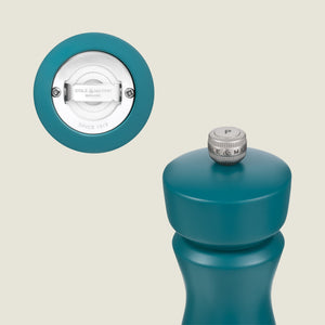 The Cole & Mason Kenton Sea Salt Blue Salt & Pepper Mill features a silver P knob, ceramic mechanism, and modern design. An inset shows the grinder and branding on the base against a light beige background.