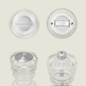 Four views of the Cole & Mason London Acrylic Salt Shaker & Pepper Mill Set, featuring clear round acrylic with metal and plastic parts—shown from top, bottom, side, and highlighting the grinder mechanism and brand label for modern table settings.