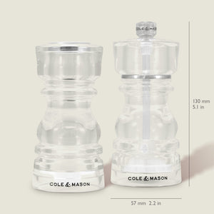 The Cole & Mason London Acrylic Salt Shaker & Pepper Mill Set includes clear, 130mm tall grinders, each 57mm wide—sleek and ideal for modern tableware settings.