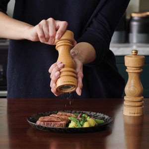 #180mm
Cole & Mason beech wood pepper mill in use over plated steak on a dark wooden kitchen counter