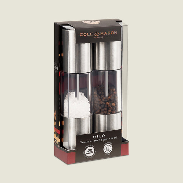 The Cole & Mason Oslo Salt & Pepper Mill Set features stainless steel and clear acrylic bodies, comes filled with sea salt and whole black peppercorns, and includes an adjustable grinding mechanism in a boxed set.