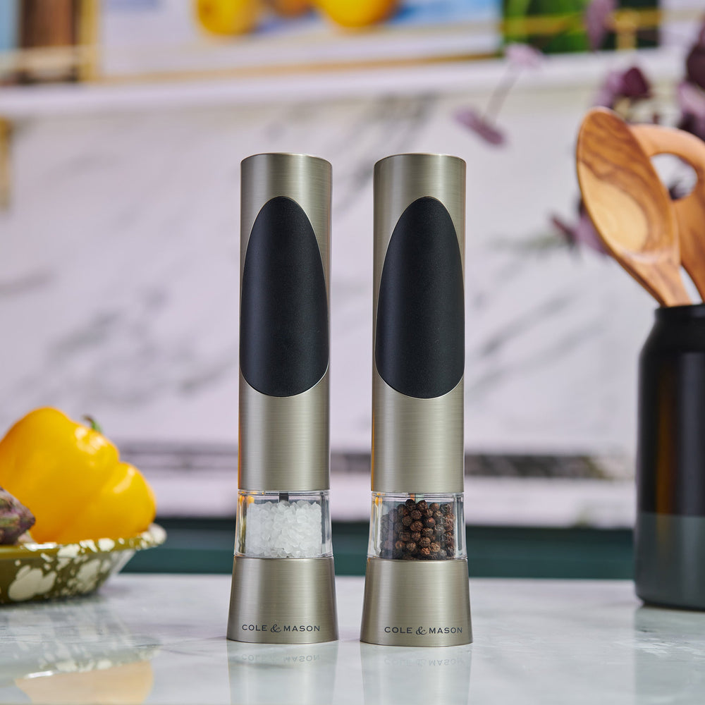 The Cole & Mason Richmond Electronic Salt & Pepper Mill Set features two stainless steel mills with black accents, each for salt or peppercorns, and offers adjustable grind levels for personalized seasoning.